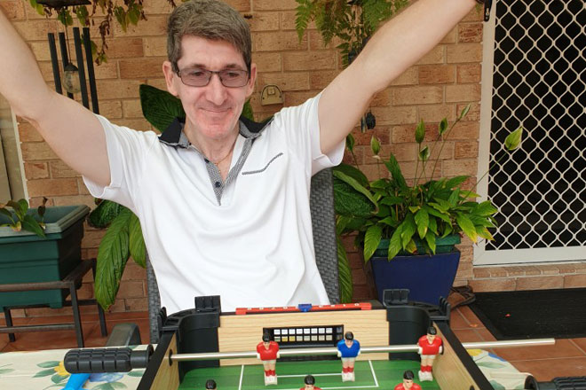 Playing table top soccer with care worker